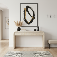 Beige console table in entryway with arched door, bench, and geometric rug