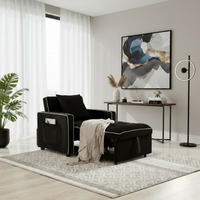 Black sleeper chair with blanket and matching background a