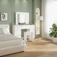 White dressing table in sage green bedroom - three-quarter angle